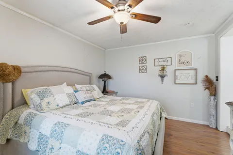 a bedroom with a bed and a chandelier