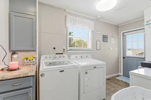 a utility room with a sink washer and dryer