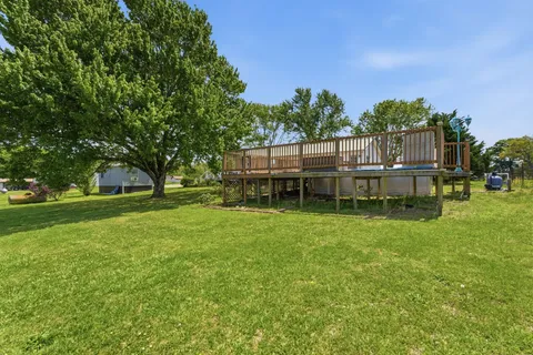 a view of a house with backyard and sitting area