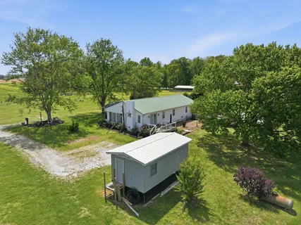 a view of a house with yard and a tree