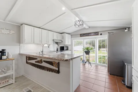a kitchen with stainless steel appliances granite countertop a stove and a sink