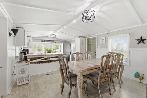 a dining room with furniture and window