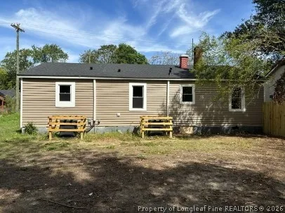 a backyard of a house with table and chairs