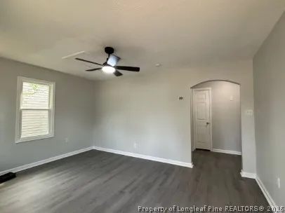 wooden floor in an empty room with a window