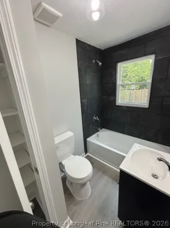 a bathroom with a toilet a sink and a bathtub