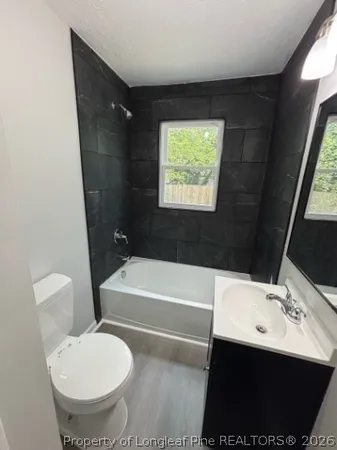 a bathroom with a sink a toilet and bathtub