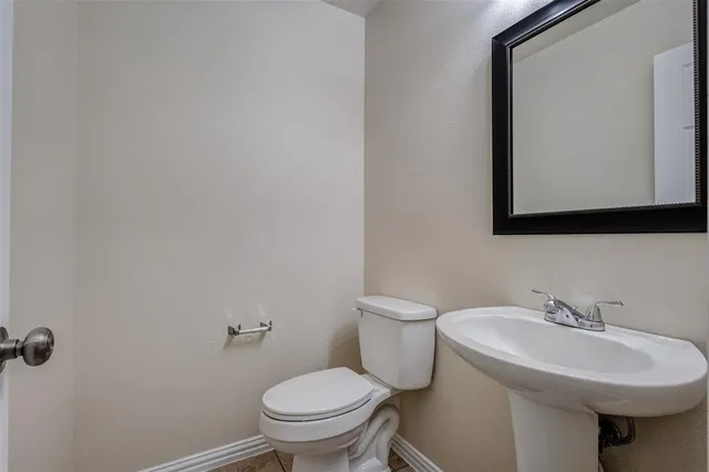 a large kitchen with stainless steel appliances granite countertop a refrigerator and a stove top oven