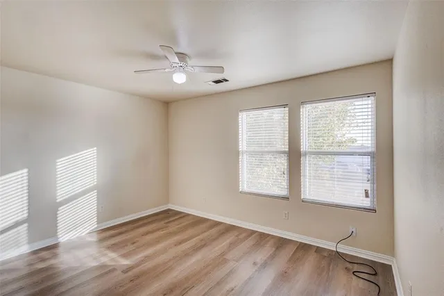 a bathroom with a granite countertop toilet sink and mirror