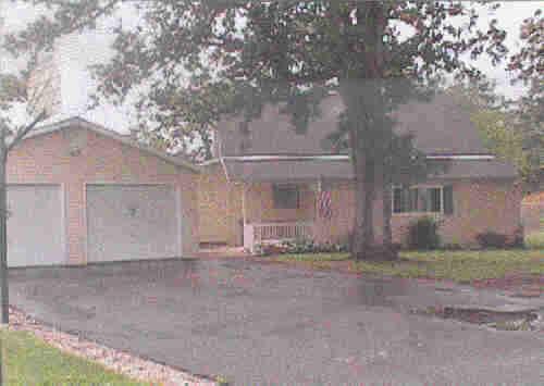 a view of a house with a yard and garage