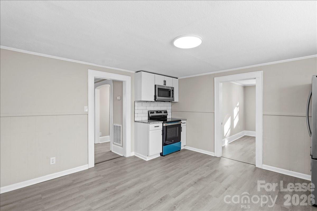 2217 Old Shelby Road Hickory, NC 28602 - Photo 12 of 20 a view of kitchen and empty room with wooden floor