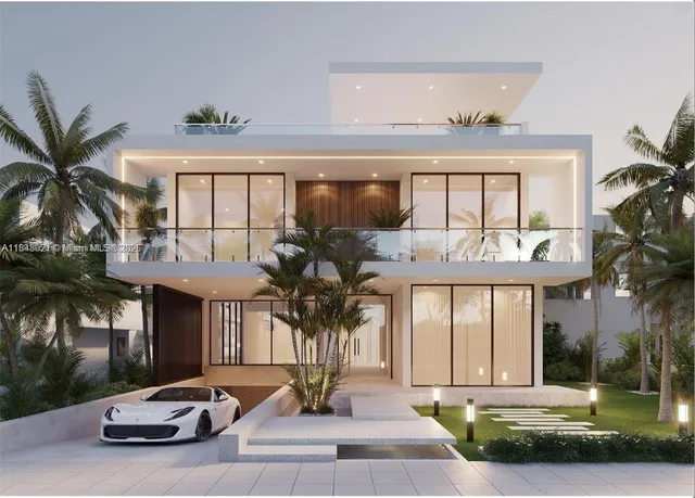 a front view of a building with glass windows and a yard