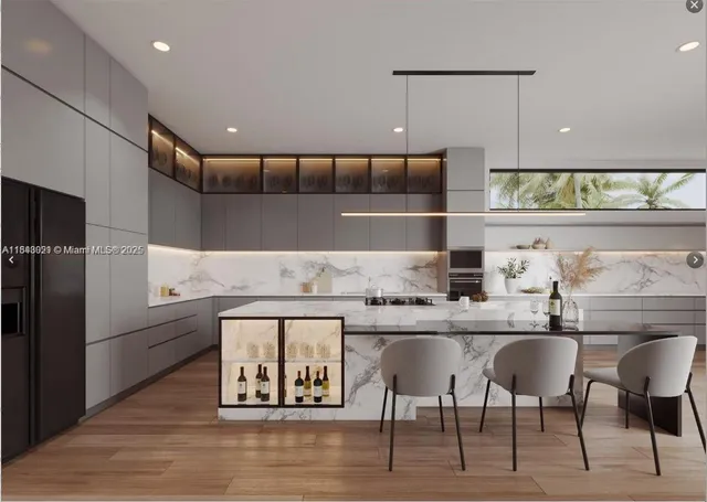 a kitchen with cabinets and chairs