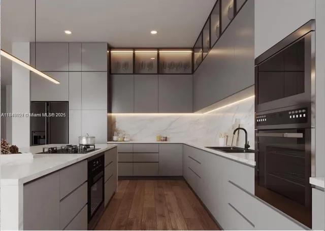 a kitchen with a sink stainless steel appliances and cabinets