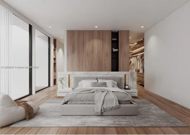 a white bed sitting in a room next to a window