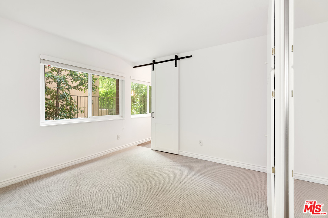 11750 Sunset Boulevard, Unit 123 Los Angeles, CA 90049 - Photo 13 of 31 a view of empty room with windows
