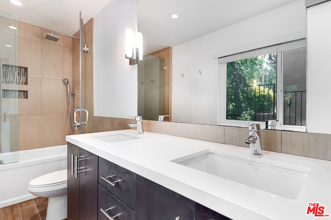 11750 Sunset Boulevard, Unit 123 Los Angeles, CA 90049 - Photo 14 of 31 a bathroom with a sink and a large mirror