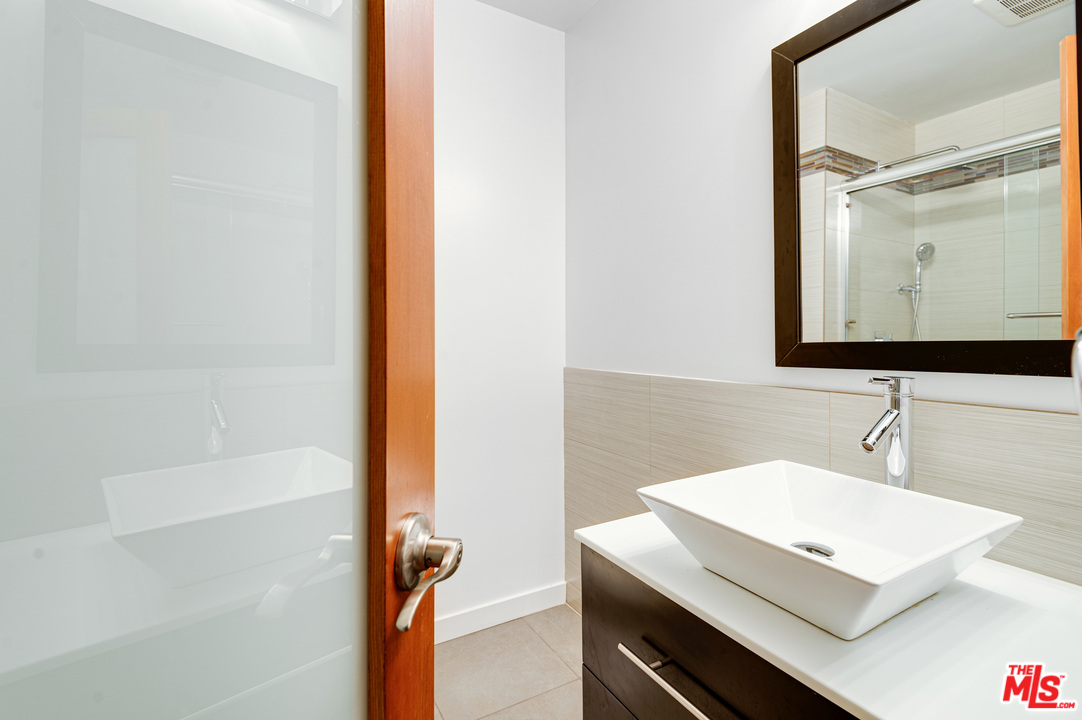 11750 Sunset Boulevard, Unit 123 Los Angeles, CA 90049 - Photo 21 of 31 a bathroom with a sink a vanity and a mirror