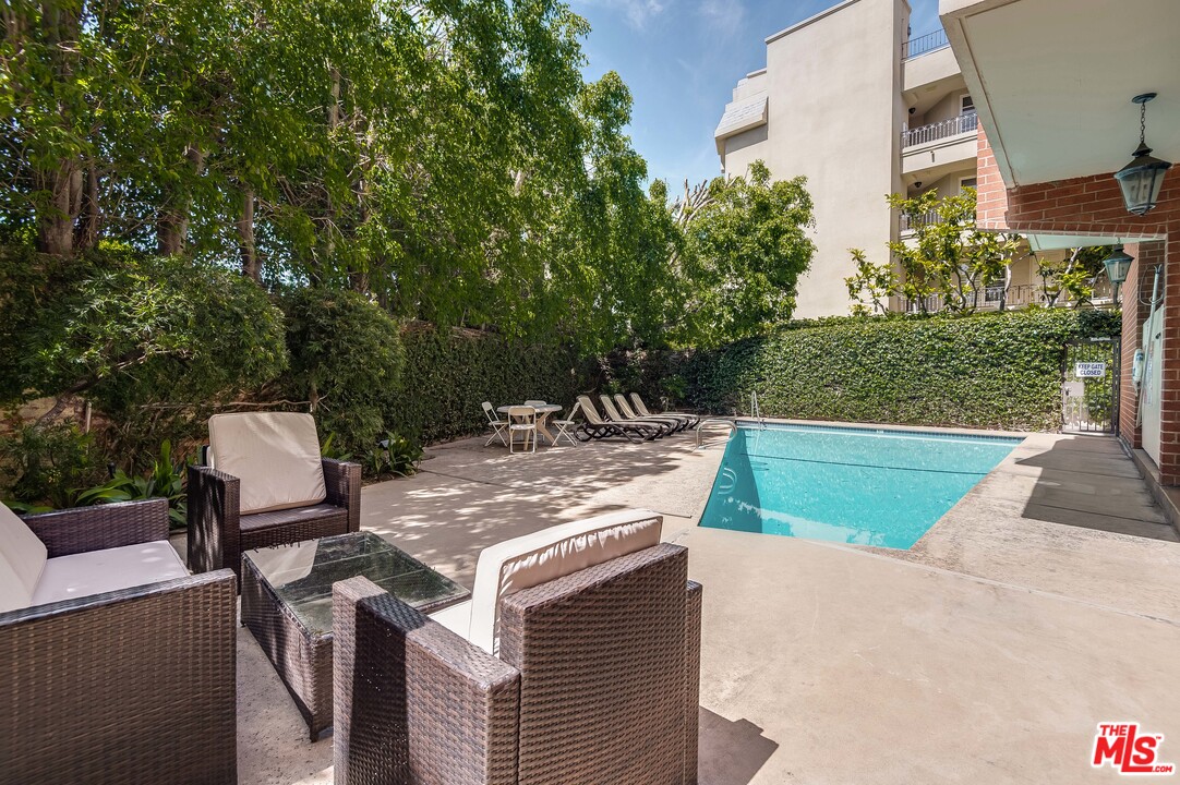 11750 Sunset Boulevard, Unit 123 Los Angeles, CA 90049 - Photo 22 of 31 a view of a chairs and table in the back yard