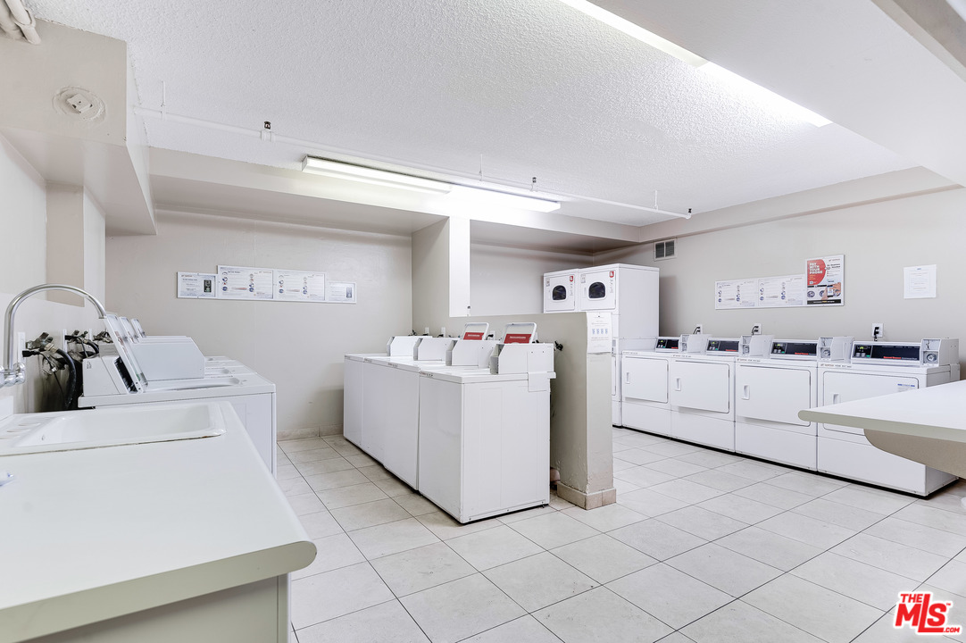 11750 Sunset Boulevard, Unit 123 Los Angeles, CA 90049 - Photo 25 of 31 a living room with white furniture and white walls