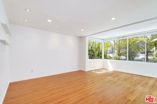 a kitchen with granite countertop a sink stove and microwave