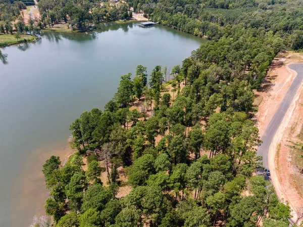 an aerial view of a house with a lake view