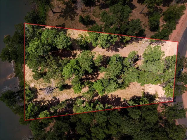an aerial view of lake and residential houses with outdoor space