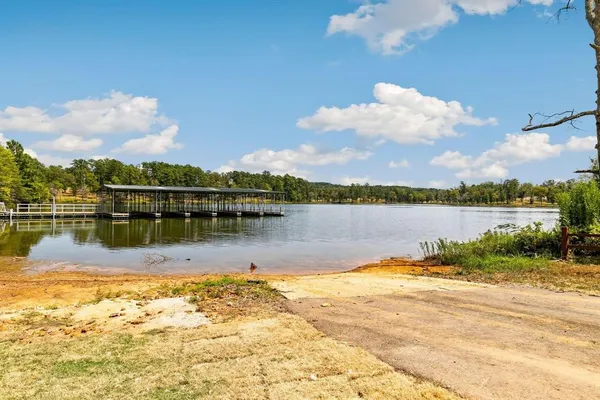 a view of a lake with houses in the background