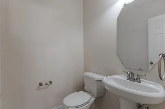 a white toilet sitting next to a bathroom sink