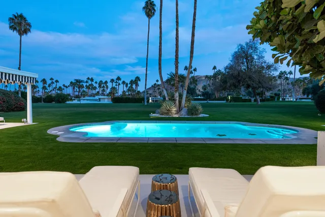 a view of a house with backyard porch and sitting area