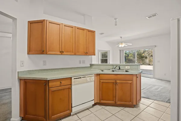 an empty room with a ceiling fan and a window