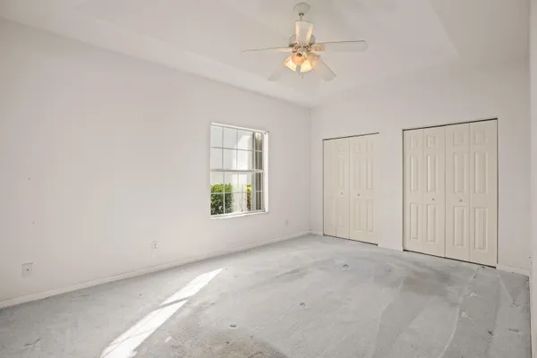 a spacious bathroom with a granite countertop sink a mirror and a bathtub