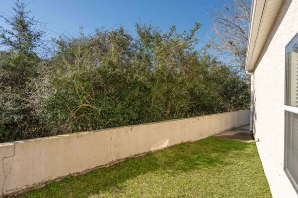 an aerial view of a house with a yard and a large tree
