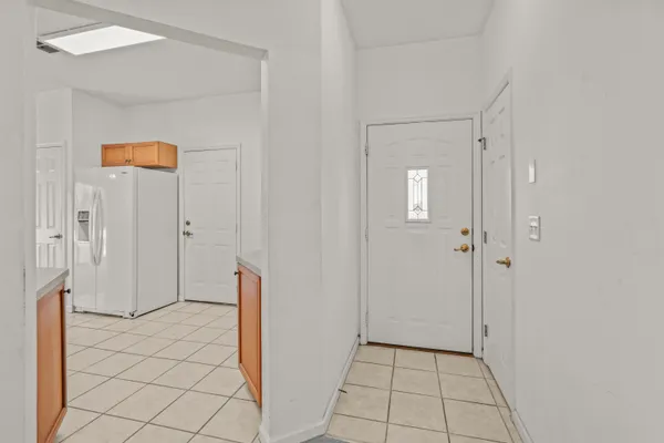 an empty room with windows and chandelier