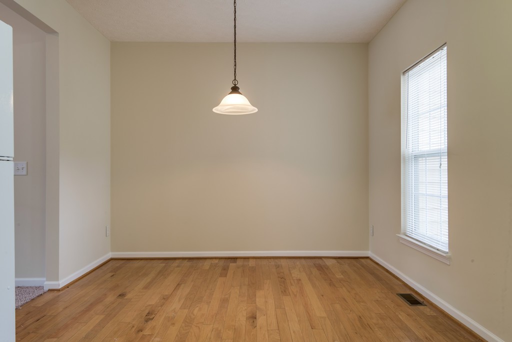 7831 Heaton Way Nashville, TN 37211 - Photo 11 of 35 a view of an empty room with a window and wooden floor