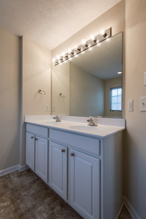 7831 Heaton Way Nashville, TN 37211 - Photo 19 of 35 a bathroom with a double vanity sink and mirror