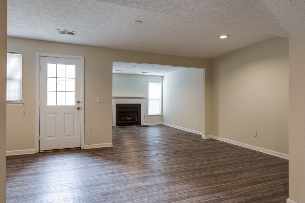 7831 Heaton Way Nashville, TN 37211 - Photo 28 of 35 an empty room with wooden floor fireplace and windows