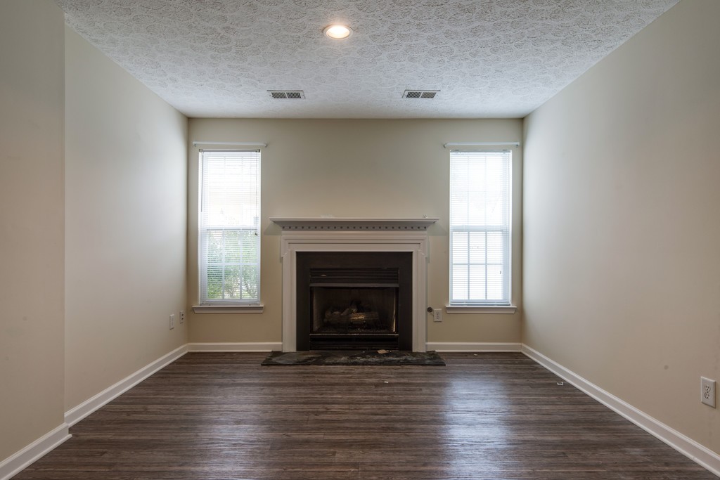 7831 Heaton Way Nashville, TN 37211 - Photo 29 of 35 a view of an empty room with wooden floor fireplace and a window
