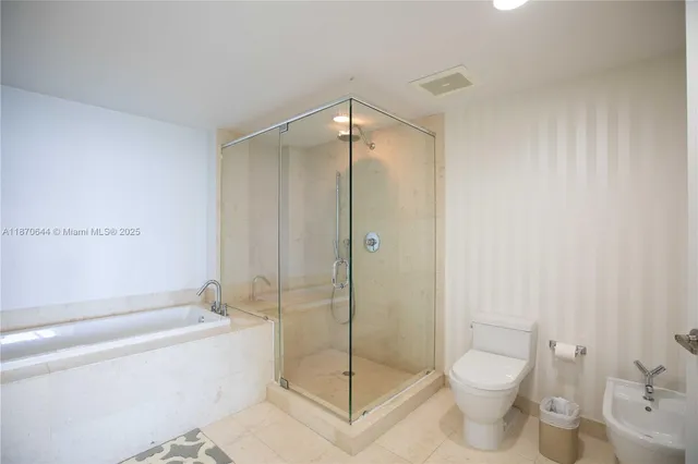 a bathroom with a shower a toilet and a shower