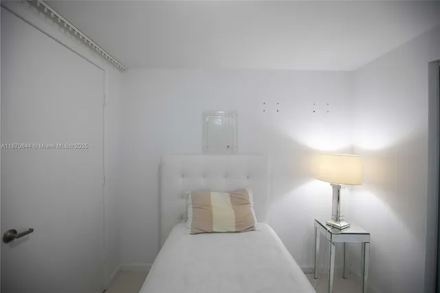 a walk in closet room with a mirror