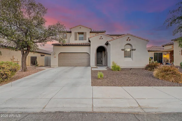 a front view of a house with a yard and garage