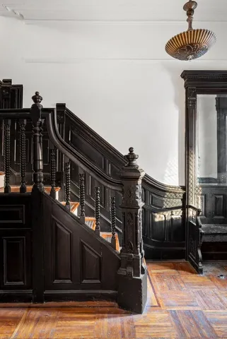 a view of a balcony with chairs and wooden floor