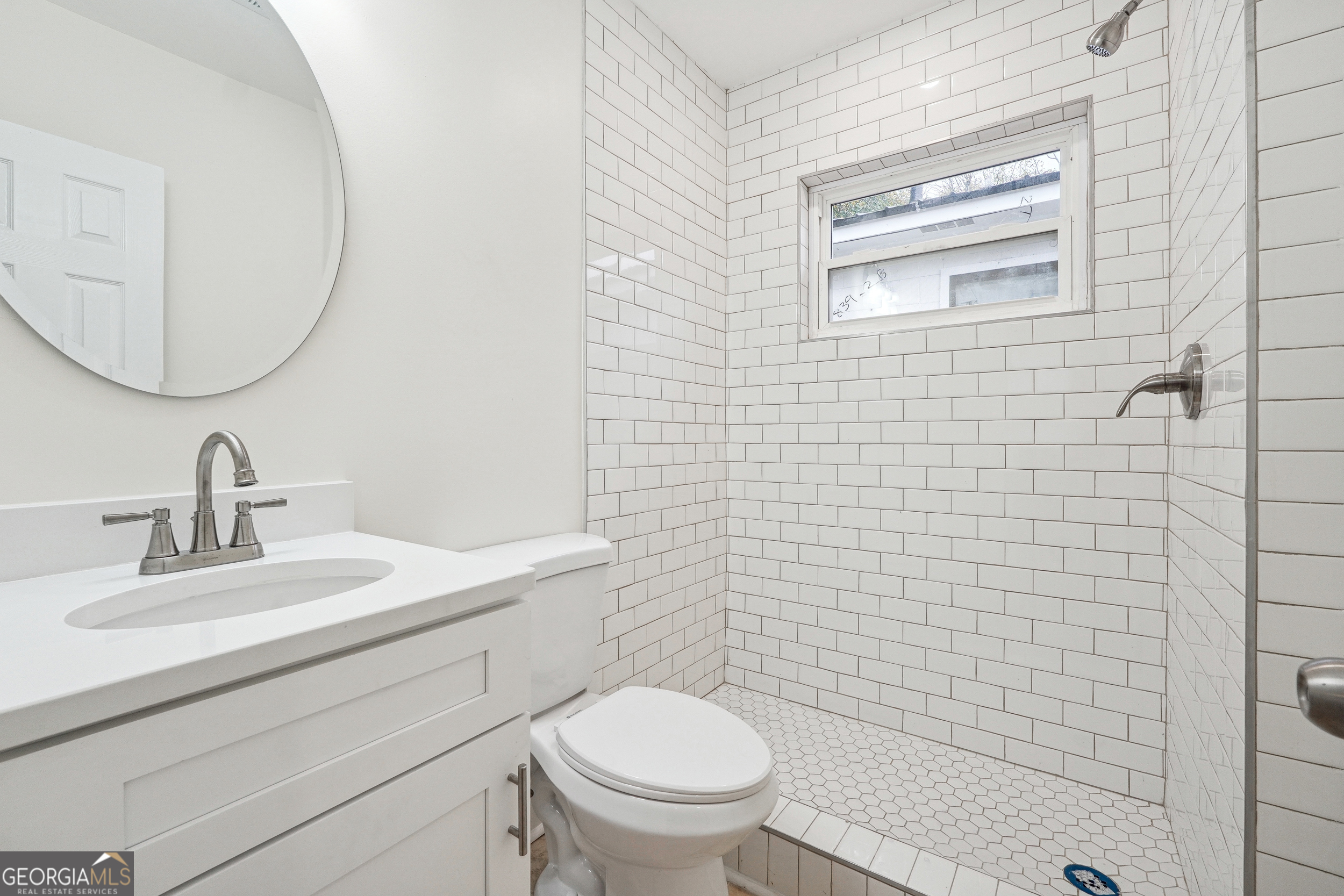 1032 Garibaldi Street Southwest, Unit B Atlanta, GA 30310 - Photo 14 of 30 a bathroom with a toilet a sink a mirror and vanity