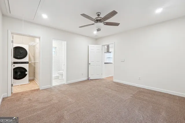 an empty room with closet and windows