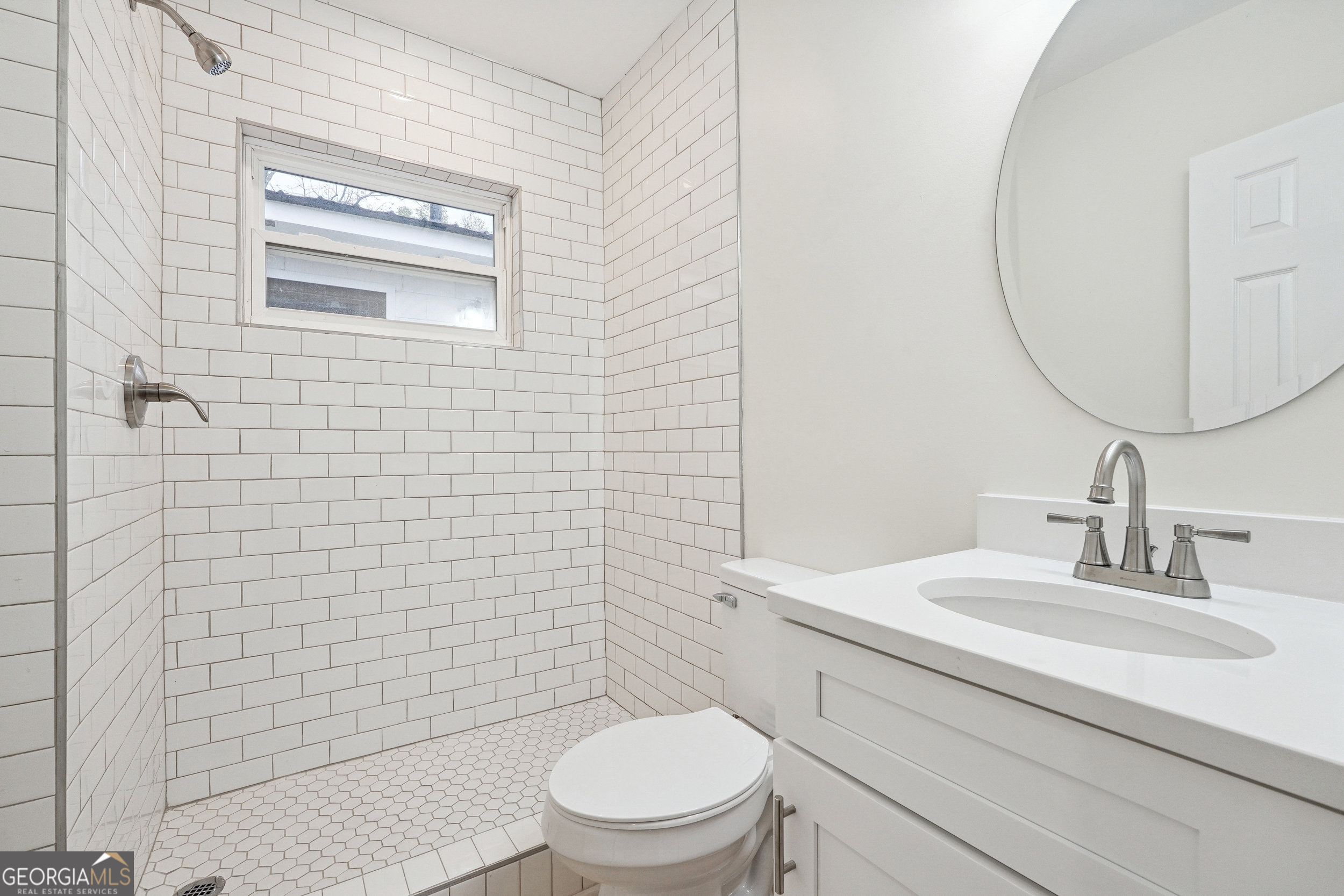 1032 Garibaldi Street Southwest, Unit B Atlanta, GA 30310 - Photo 23 of 30 a bathroom with a toilet a sink and mirror