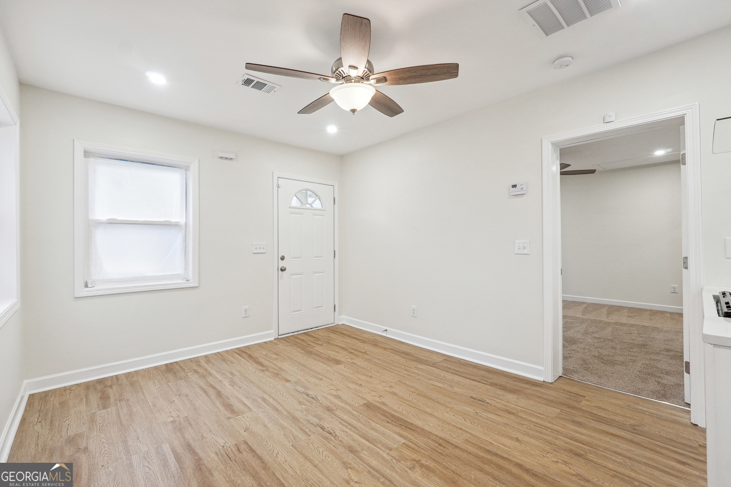 1032 Garibaldi Street Southwest, Unit B Atlanta, GA 30310 - Photo 24 of 30 an empty room with wooden floor and windows
