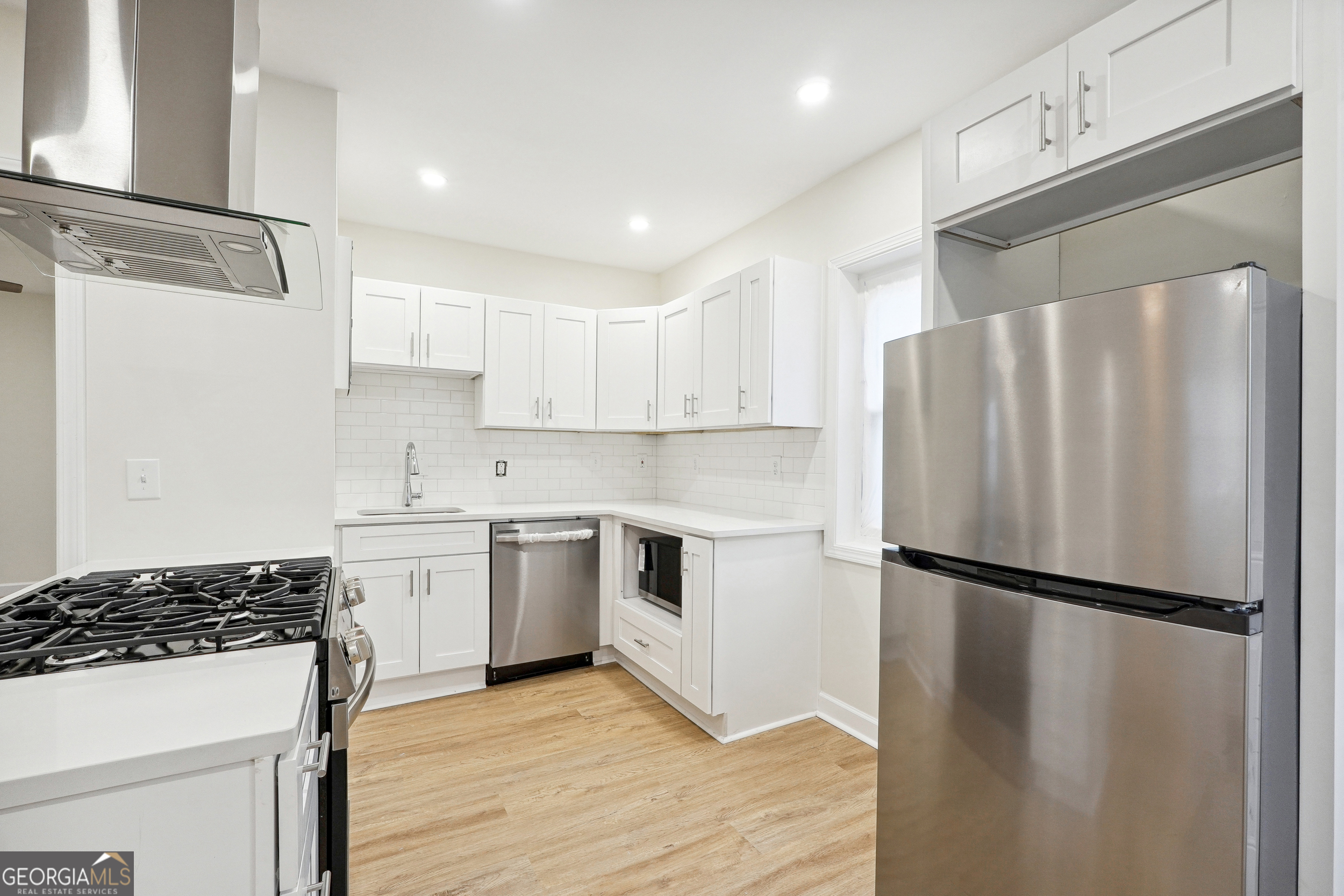 1032 Garibaldi Street Southwest, Unit B Atlanta, GA 30310 - Photo 26 of 30 a kitchen with granite countertop a refrigerator stove and sink