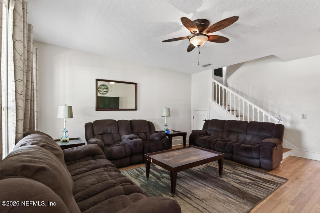45107 South Booth Street Callahan, FL 32011 - Photo 12 of 68 a living room with furniture a ceiling fan and a rug