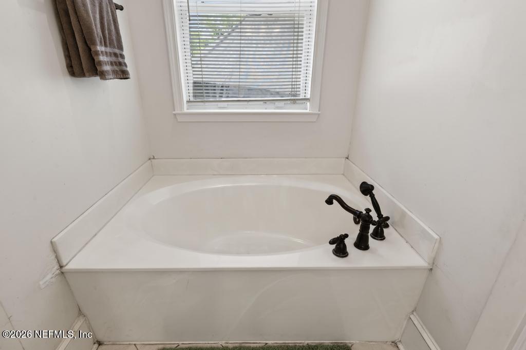 45107 South Booth Street Callahan, FL 32011 - Photo 35 of 68 a white bath tub sitting next to a window