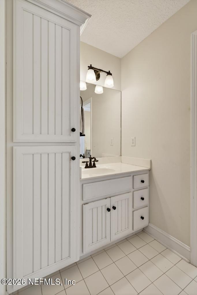 45107 South Booth Street Callahan, FL 32011 - Photo 42 of 68 a bathroom with a double vanity sink a mirror and a