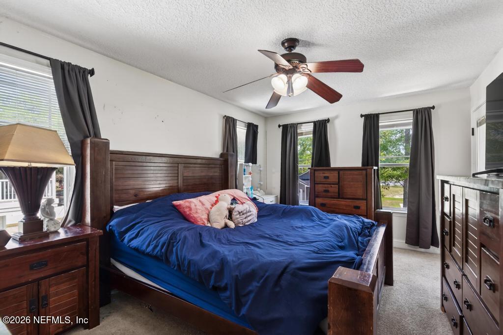 45107 South Booth Street Callahan, FL 32011 - Photo 46 of 68 a bedroom with a bed a dresser and window